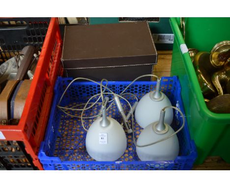 A modern pendant light and a storage box.