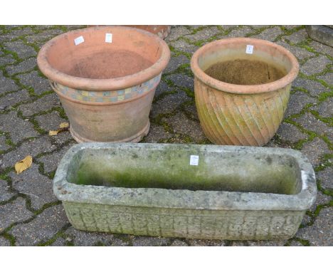 Two terracotta plant pots and a garden trough.