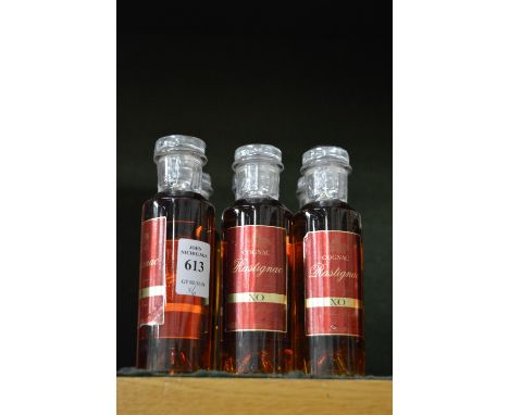 Six miniature bottles of Rastignac XO cognac.