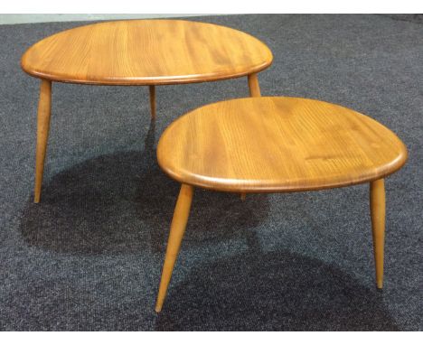 Ercol Furniture - A nest of two elm and beech 'Pebble' tables, width of largest 65cm. (2)