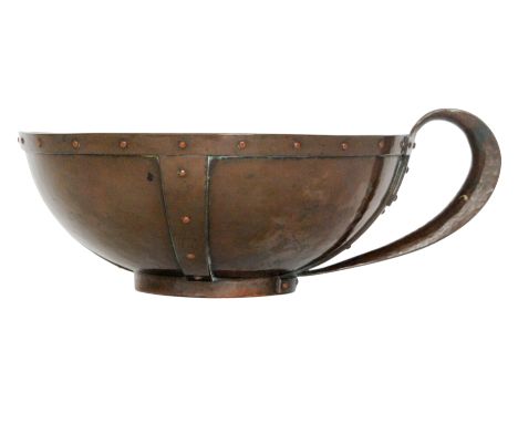 Unknown - An early 20th Century Arts and Crafts copper chamber stick, the bowl shaped body with planished panels and riveted 