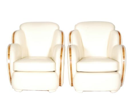 Unknown - An Art Deco three-piece cloud shaped lounge suite, including a three seat sofa, upholstered in cream leather with a