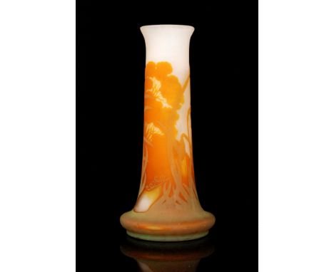 Galle - A large early 20th Century cameo glass vase of footed sleeve form with everted rim, cased in pale green over amber ov