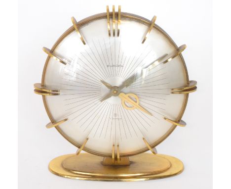 Europa - A post-war Continental mantle clock with stepped brass base below a silvered dial with radial design and outer brass