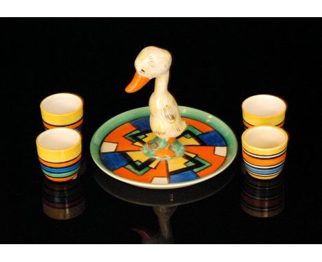 Clarice Cliff - Mondrian - Mr Duck - A Mr Duck egg cup set circa 1929, with a circular dish form base radially hand painted w