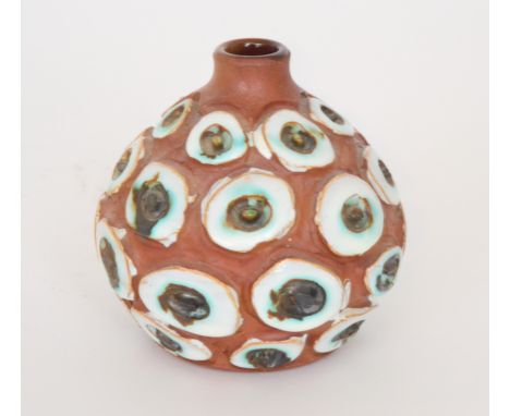 Beatrice Bolton - Poole Pottery - An Atlantis vase of onion form, the red terracotta body with carved disc shapes glazed in w