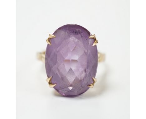 A modern 9ct gold and oval cut amethyst set dress ring, size M, gross weight 5.9 grams.