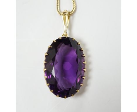 A yellow metal mounted single stone oval cut amethyst set pendant, 35mm, on a yellow metal chain, 48cm, gross weight 10.7 gra