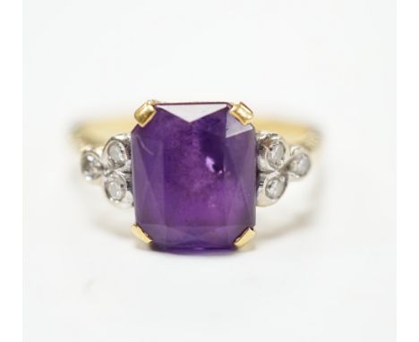 An 18ct and single stone emerald cut amethyst set ring with diamond set shoulders, size M, gross weight 4.5 grams.