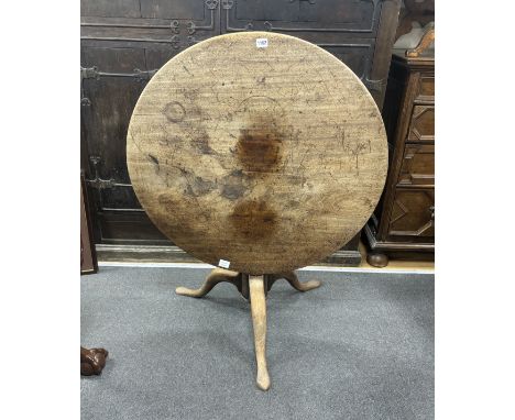 A George III circular faded mahogany tilt top tripod tea table, diameter 89cm, height 68cm