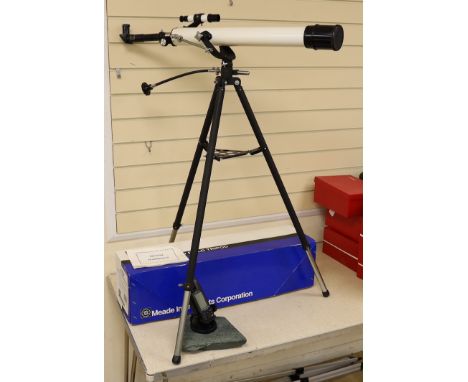 A telescope on tripod stand and a Meade scope and tripod, telescope and stand 105cm high