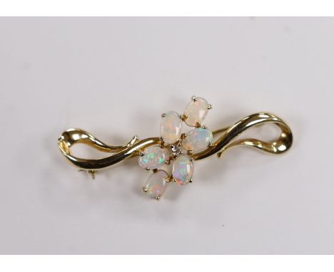 A 14k and six stone white opal cluster set brooch, 45mm, gross weight 5 grams.