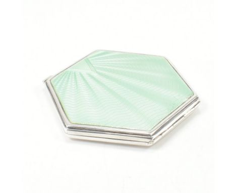 A hallmarked Art Deco silver and guilloche enamel powder compact. The compact decorated with green guilloche enamelling openi