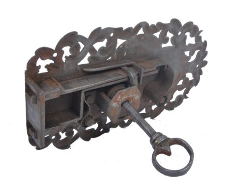 A 17th century German engraved steel lock and key in good condition, the steel case having a worked foliate pierced plate wit