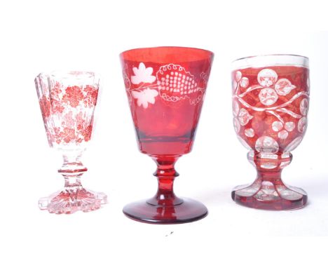 A group of x3 19th century ruby and acid etched glass wine drinking glasses comprising an tapering bowl example with leaf and