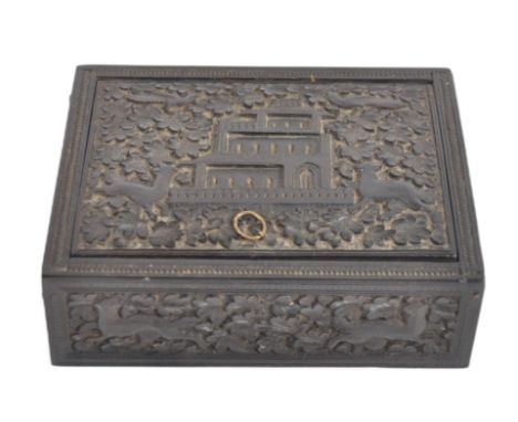 A 19th century Anglo Indian hand carved wooden trinket Box. Black hardwood of square form intricately carved with floral, ani