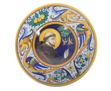 An early 20th Century Italian antique style Majolica hand painted hanging plate having a central scene depicting a Monk with 