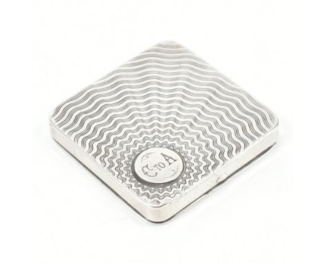 A hallmarked silver Art Deco compact case. The case decorated with a sunburst design with monogram cartouche, having engine t