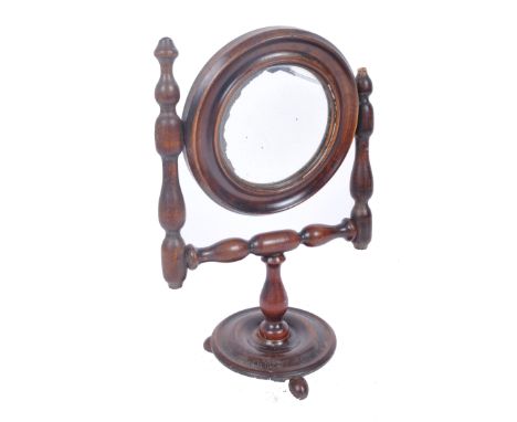 A Victorian 19th century walnut ladies toilet dress swing mirror raised on bobbin arms over circular base with finial feet. A