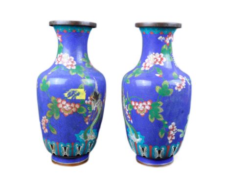 A pair of early 20th Century Chinese Cloisonne vases. Baluster form with polychrome enamel decoration depicting flowers, myth