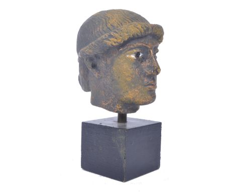 A 20th century Roman style portrait bust. The portrait of a soft featured figure with neutral expression detailing with brass