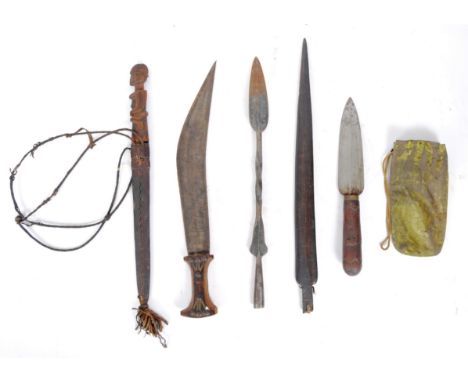 Collection of African tribal weapons to include wooden daggers, one with bust head to handle with leather scabbard, one lacki