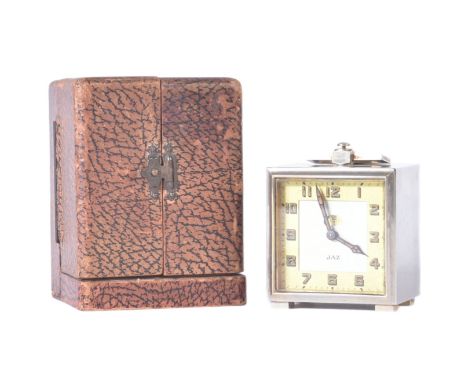 A 1930s French made chrome plated travel clock by Jaz. Bevelled surround, standing on squared feet and marked 'Made In France