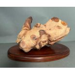 An ornamental piece of driftwood on plinth