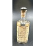 A vintage eau de cologne bottle with a cork stopper