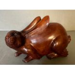 A carved wooden ornamental hare