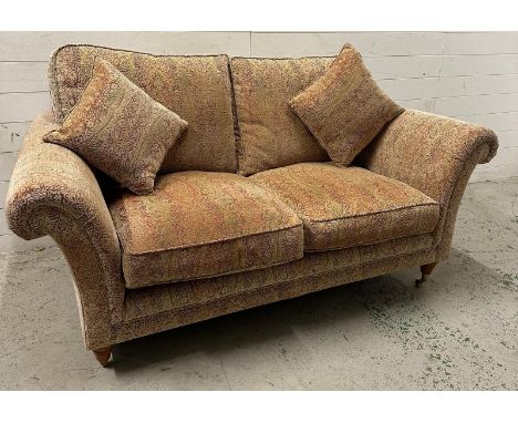 A two seater Parker Knoll sofa upholstered in a floral pattern 