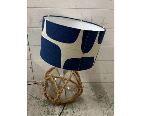 A glass marine themed table lamp with rope webbing 