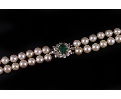 A fine modern twin strand pearl necklace, the two rows of uniform white cultured pearls united by a large white metal cluster