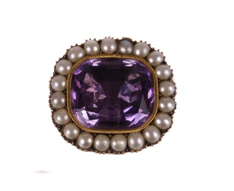 A 19th century amethyst and seed pearl brooch, the foil backed cut purple stone with seed pearl surround with gold back, old 