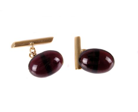 A pair of garnet mounted dress cufflinks, the yellow metal mounts supporting a red cabuchon stone, AF, with chain links and b