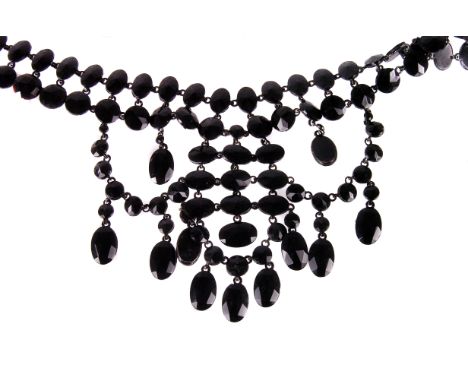 A vintage French Jet fringe necklace, having two rows of faceted black glass cut beads leading to swag fringe drop on black e