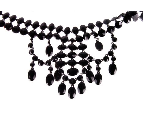 A vintage French Jet fringe necklace, having two rows of faceted black glass cut beads leading to swag fringe drop on black e