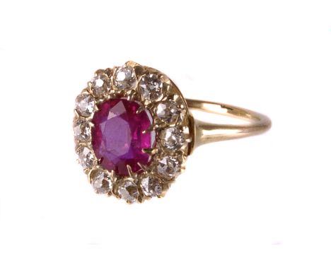 A certified ruby and diamond cluster dress ring, having an oval cushion cut red stone, certified at 1.37ct in claw setting su