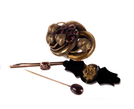 Three antique brooches, one pinchbeck vine and leaf knotted example with purple faceted stones, one being a gem set bar brooc