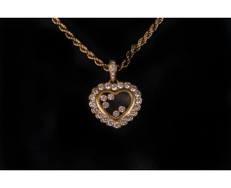 A fine 18ct gold and diamond heart shaped pendant from Chopard, having diamond set outer and glazed panel to centre set with 