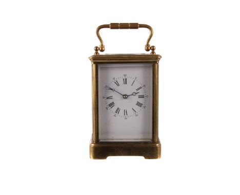 A late 19th century brass repeater carriage clock, with white enamel dial and black Arabic numerals, striking on a coil, with