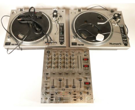 A pair of Numark turntables, TT-1520, together with a Behringer DJ mixer deck, model DJX 700. 