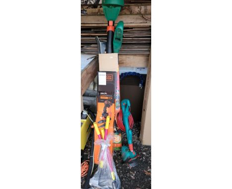 A group of electric garden tools to include a Black &amp; Decker 55cm hedge trimmer, Bosch strimmer, accessories, and a boxed