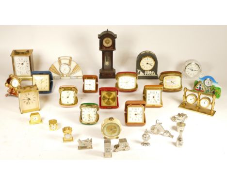 A collection of mid 20th century and later mantel clocks and traveling alarm clocks, having manual wind and quartz movements,