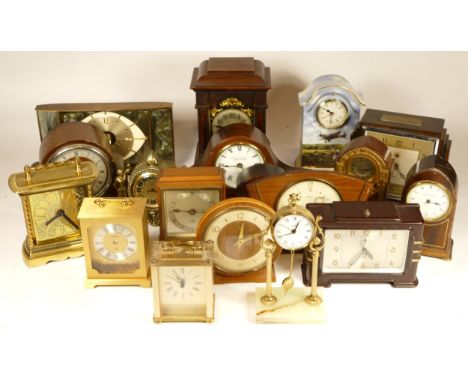 A collection of mid 20th century and later mantel clocks and traveling alarm clocks, having manual and quartz movements, in t