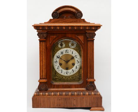An early 20th century walnut cased dome topped mantle clock, the brass dial with two subsidiary dials, 53cm high. 