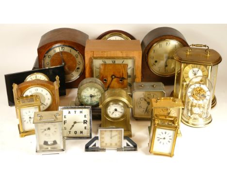A collection of mid 20th century and later mantel clocks and traveling alarm clocks, having manual and quartz movements, in t