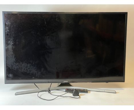 A Samsung TV 40 inch, model VE40 MU6120K, with power lead and remote control. 