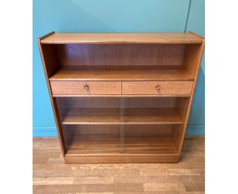 A Nathan teak display cabinet, having open shelf over two long drawers, flanked by two glazed sliding doors opening to reveal