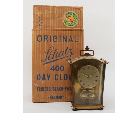 A boxed Schatz brass cased anniversary clock complete with instruction, 20cm high (with additional wire and key). 